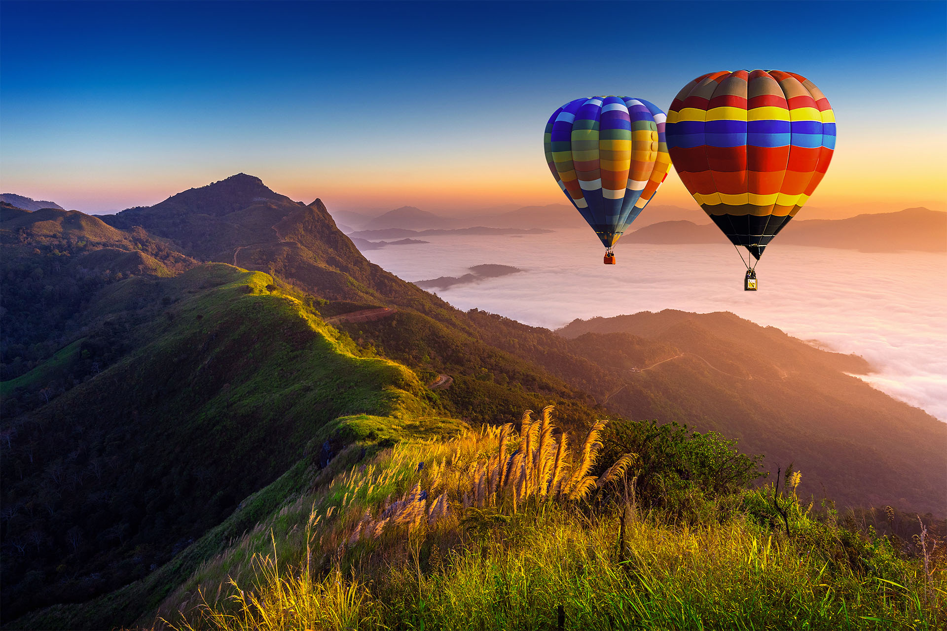 Landscape of morning fog and mountains with hot air balloons at